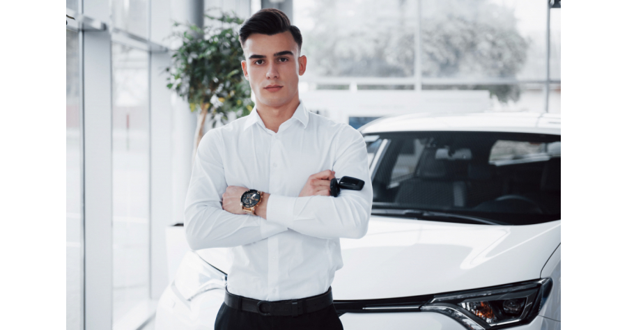 handsome-man-is-buyer-standing-new-car-dealer-center-looking-camera (1)
