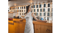 girl-wearing-an-apron-mockup-relaxing-at-a-tea-bar-a19820_optimized